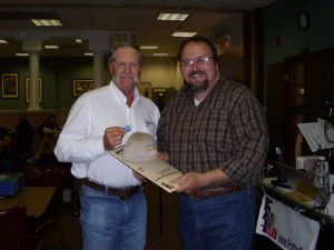 News/Talk 1290's Mike Hendren (r) awarding a Pratt on Texas calendar and 1290 cap to a listener.