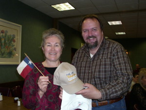 News/Talk 1290's Mike Hendren awards a station cap and t-shirt to a listener - the Texas flag came from Pratt on Texas.